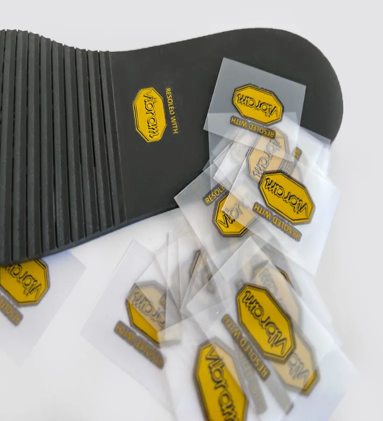 Plastic heat transfers applied to a rubber outsole